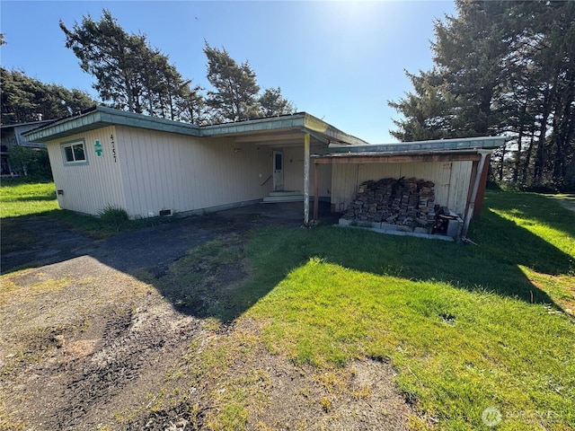 4757 State Route 109, Moclips, WA 98562 - view of front facade with a front yard, dirt driveway, and an attached carport