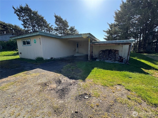 4757 State Route 109, Moclips, WA 98562 - view of front of house featuring a front yard, dirt driveway, and an attached carport