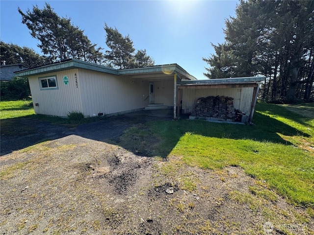4757 State Route 109, Moclips, WA 98562 - view of front facade featuring a front yard, dirt driveway, and an attached carport
