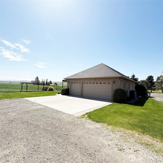 1078 Gardena Creek Rd, Touchet, WA 99360 - view of side of property with concrete driveway, a garage, a yard, and stucco siding