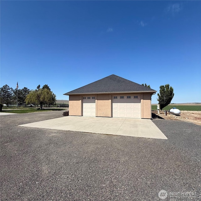 1078 Gardena Creek Rd, Touchet, WA 99360 - view of home's exterior featuring a garage and stucco siding