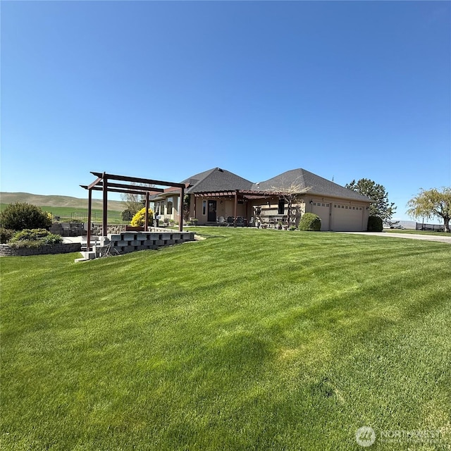 1078 Gardena Creek Rd, Touchet, WA 99360 - view of green lawn featuring a pergola and an attached garage