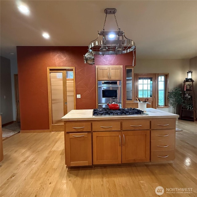 1078 Gardena Creek Rd, Touchet, WA 99360 - kitchen with stainless steel appliances, light wood-style flooring, light countertops, a center island, and recessed lighting
