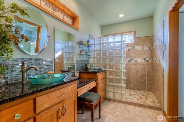 1078 Gardena Creek Rd, Touchet, WA 99360 - bathroom featuring walk in shower, vanity, tile patterned flooring, and backsplash
