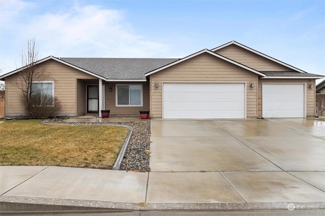 ranch-style home featuring a garage and a front yard