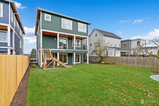 rear view of house featuring a lawn