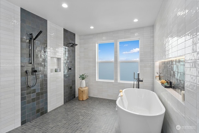 bathroom featuring tile walls, tile patterned floors, and independent shower and bath