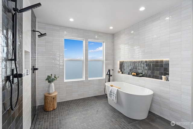 bathroom featuring tile patterned floors, tile walls, and separate shower and tub