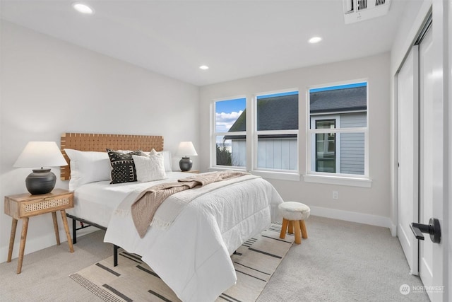 bedroom with a closet and light carpet