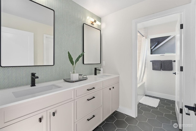 bathroom featuring tile patterned flooring, shower / bath combo with shower curtain, decorative backsplash, and vanity