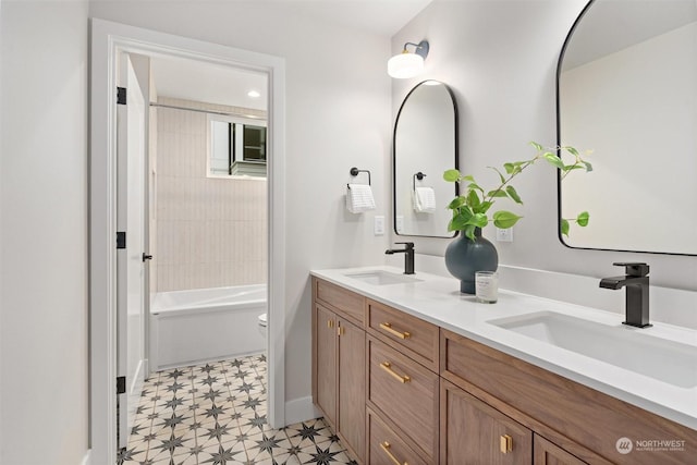 full bathroom featuring toilet, tiled shower / bath combo, and vanity