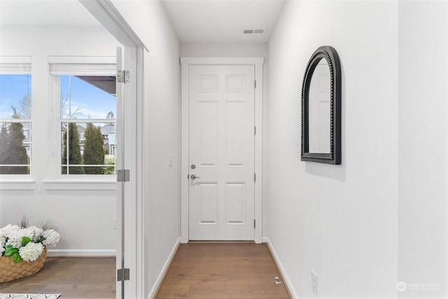 doorway to outside with wood-type flooring