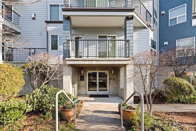 view of exterior entry with a balcony