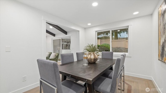 dining space with light wood-style flooring, baseboards, beamed ceiling, and recessed lighting