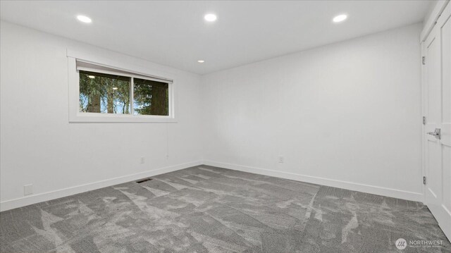 carpeted empty room with baseboards and recessed lighting