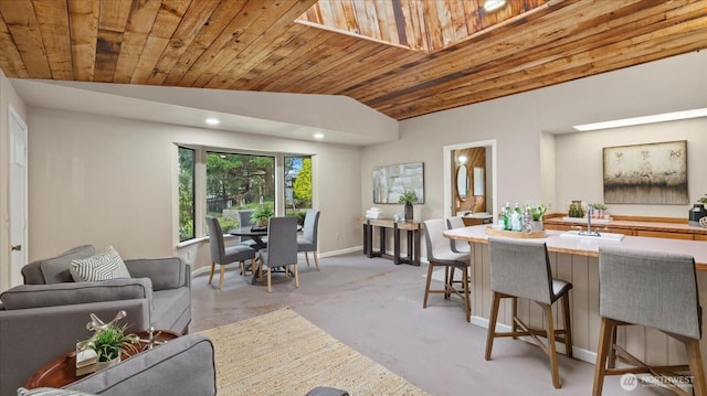 dining space featuring lofted ceiling, recessed lighting, light carpet, wood ceiling, and baseboards