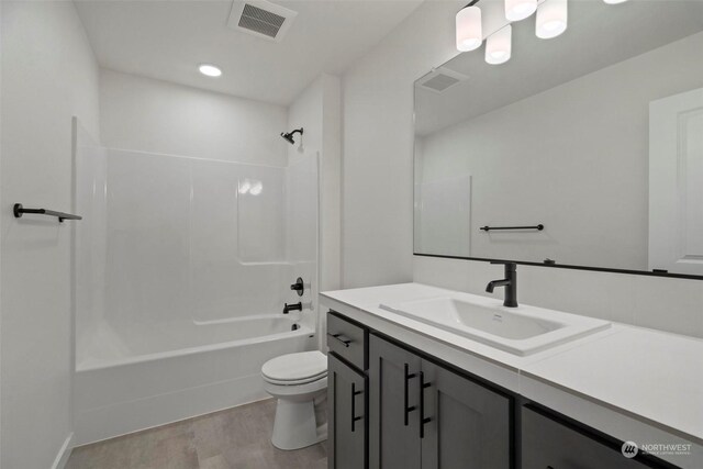 full bathroom featuring toilet, vanity, shower / bath combination, and hardwood / wood-style flooring