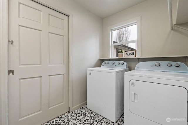 clothes washing area featuring separate washer and dryer and light tile patterned floors