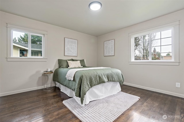 bedroom featuring dark hardwood / wood-style flooring and multiple windows