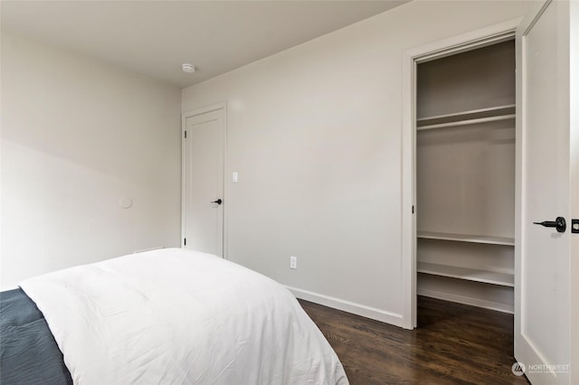 bedroom featuring a closet and dark wood-type flooring