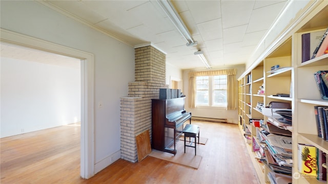 misc room with crown molding, hardwood / wood-style floors, and a baseboard radiator