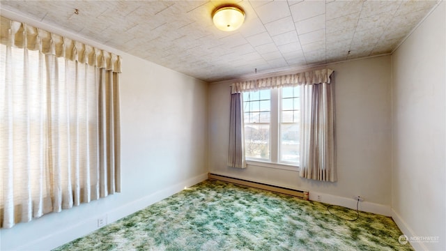 spare room with carpet floors and a baseboard radiator