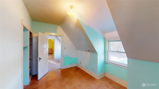 additional living space featuring vaulted ceiling