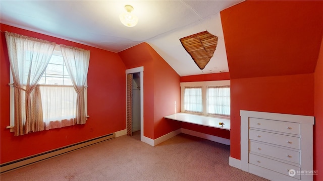 unfurnished bedroom featuring multiple windows, light colored carpet, baseboard heating, and lofted ceiling