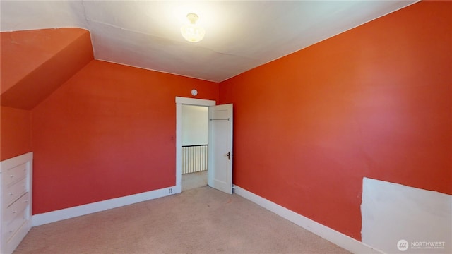 additional living space featuring baseboards and carpet