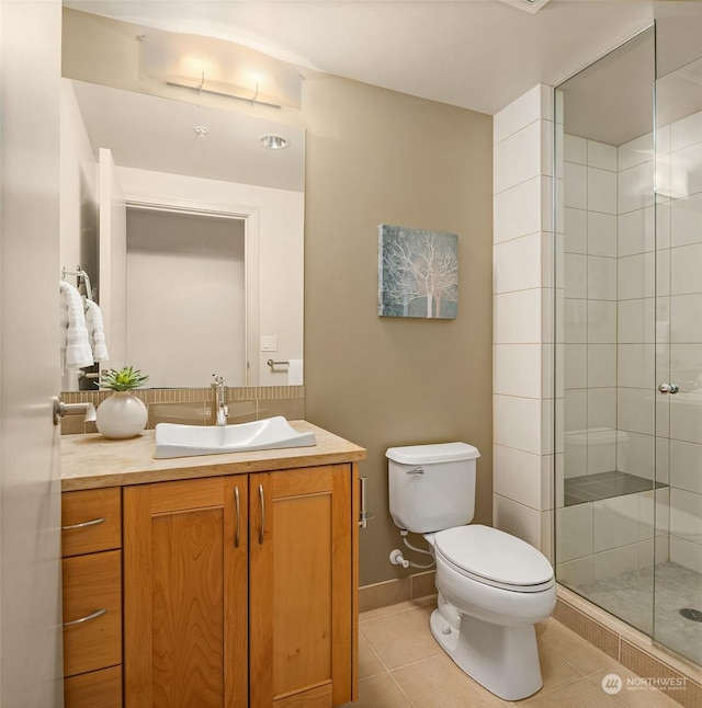 bathroom with tile patterned floors, vanity, toilet, and walk in shower