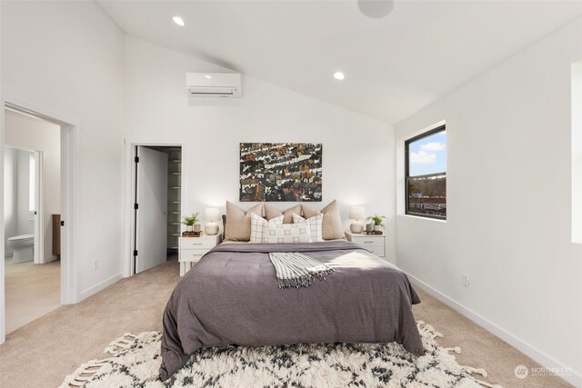 carpeted bedroom with ensuite bathroom, lofted ceiling, and a wall mounted AC