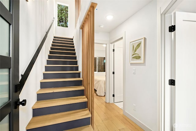 stairway with hardwood / wood-style floors