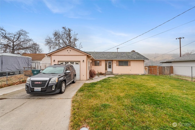 view of front of home featuring a garage and a front lawn