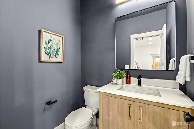 bathroom with vanity and toilet