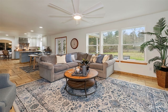 living room featuring plenty of natural light and ceiling fan