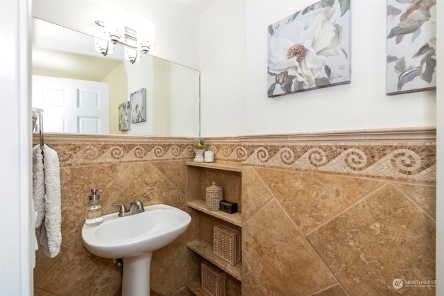 bathroom with tile walls and sink