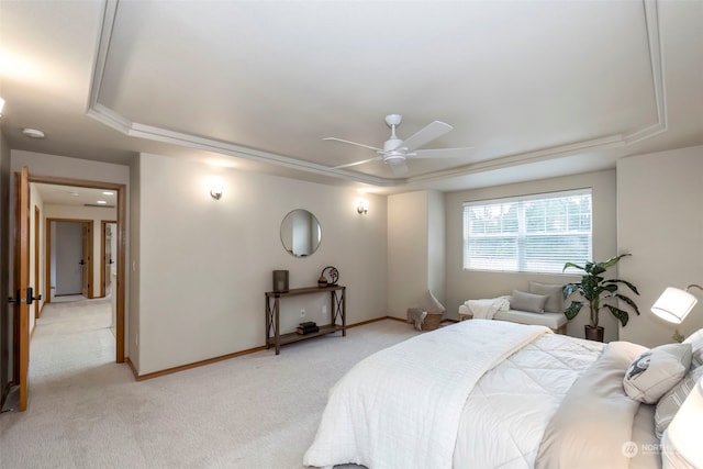 bedroom with ceiling fan, a raised ceiling, and light colored carpet