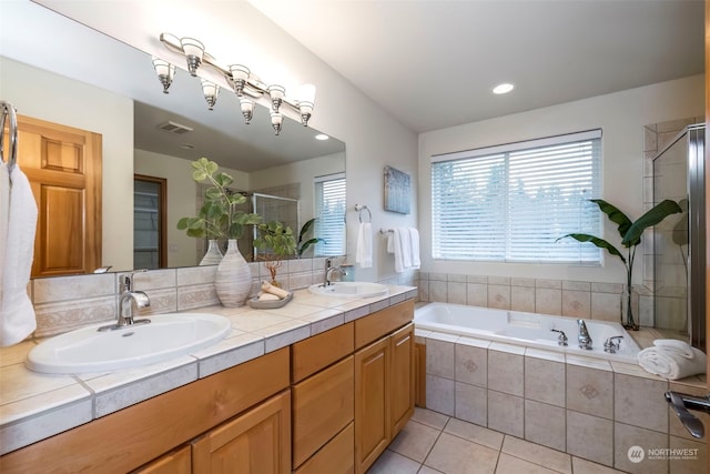 bathroom with plus walk in shower, vanity, and tile patterned floors