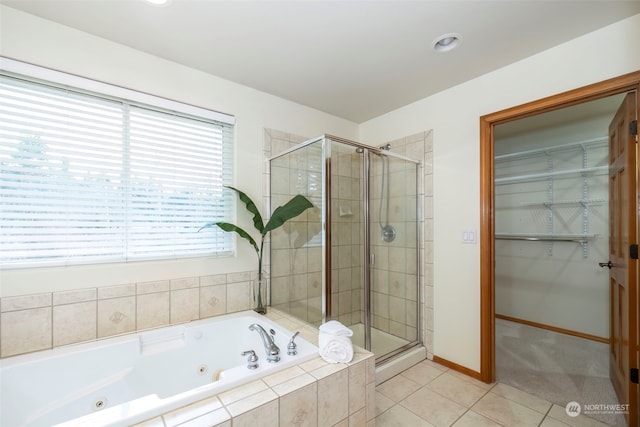 bathroom featuring tile patterned flooring and separate shower and tub