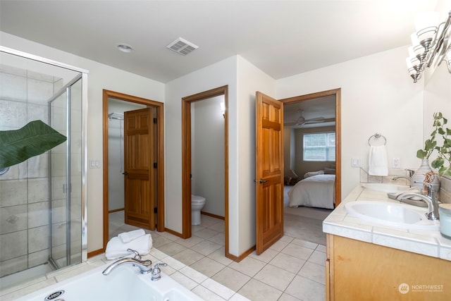 full bathroom with tile patterned flooring, vanity, separate shower and tub, and toilet