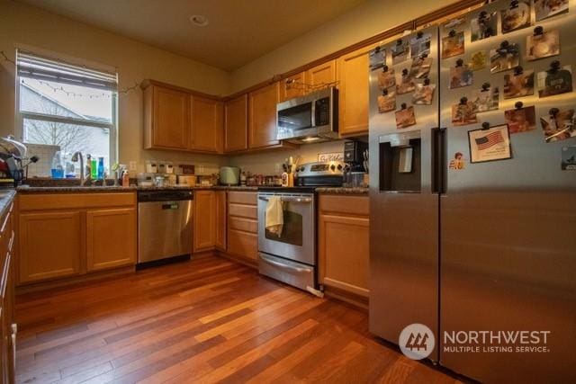 kitchen with hardwood / wood-style floors, sink, and appliances with stainless steel finishes