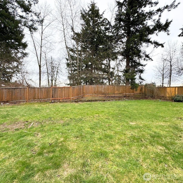 view of yard with a fenced backyard