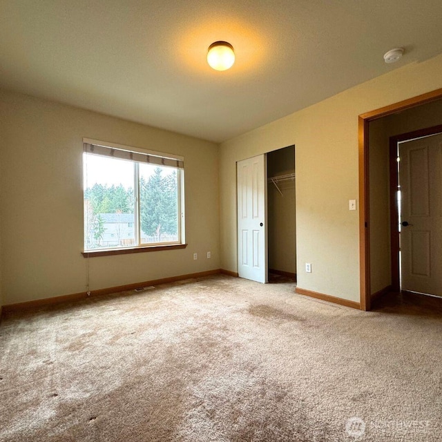 unfurnished bedroom featuring a closet, baseboards, carpet, and visible vents