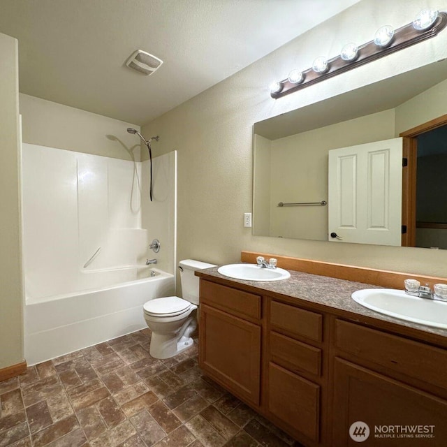 bathroom with a sink, visible vents, toilet, and double vanity