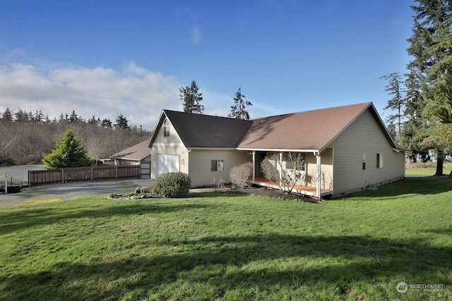 back of property featuring a yard and a garage