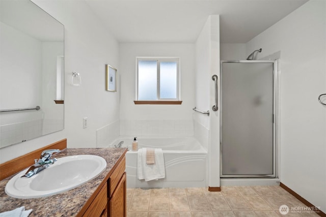 full bathroom with a stall shower, a garden tub, and vanity