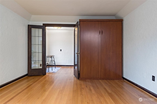 interior space featuring french doors and light hardwood / wood-style floors