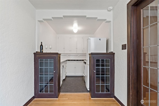 corridor featuring light hardwood / wood-style floors