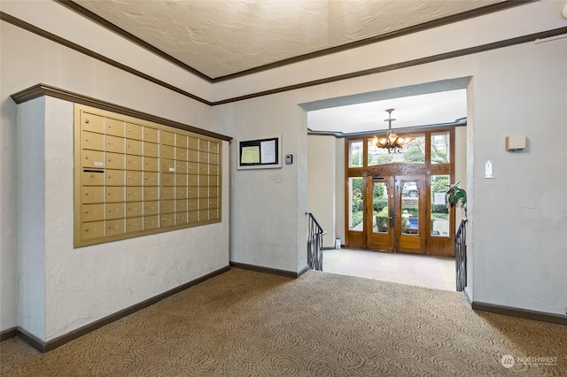 interior space featuring carpet floors, a chandelier, a mail area, and ornamental molding