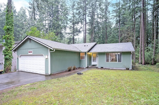 single story home featuring a garage and a front lawn